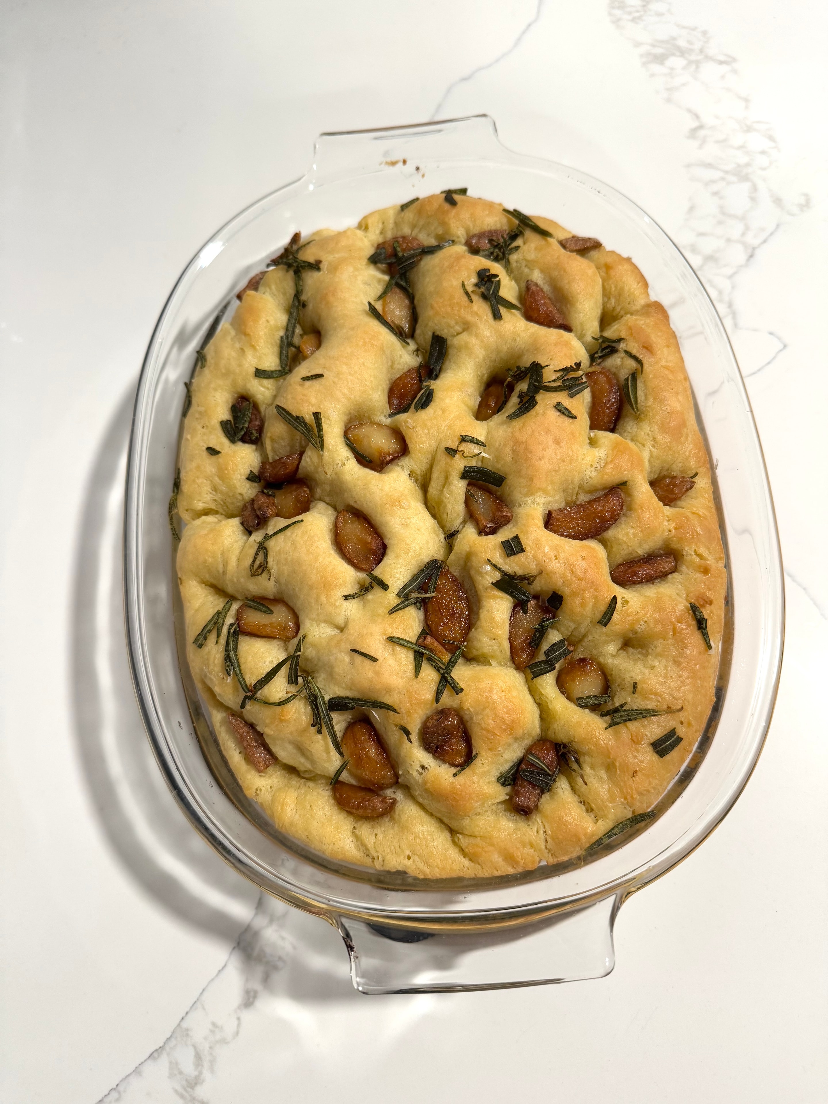 Rosemary garlic focaccia in a glass baking dish